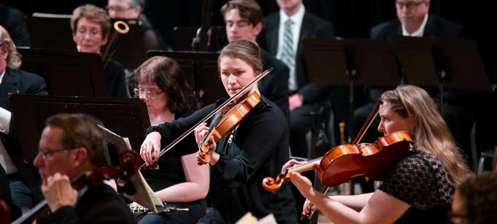 orchestra group closeup of violin player